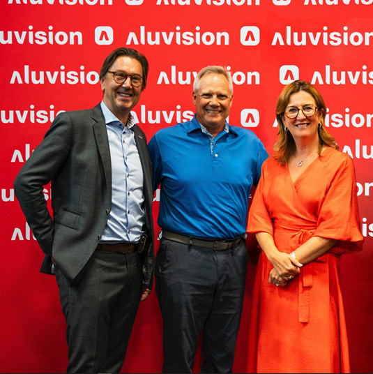 Aluvision owners Dirk Deleu (left) and Ann Vancoillie (right) stand with Robert Laarhoven (middle) 